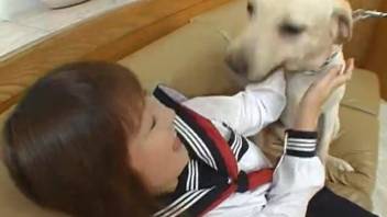 Young Japanese girl is tongued and banged by the canine in a bizarre spectacle