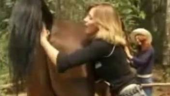 Smoldering women taking turns with a huge horse cock